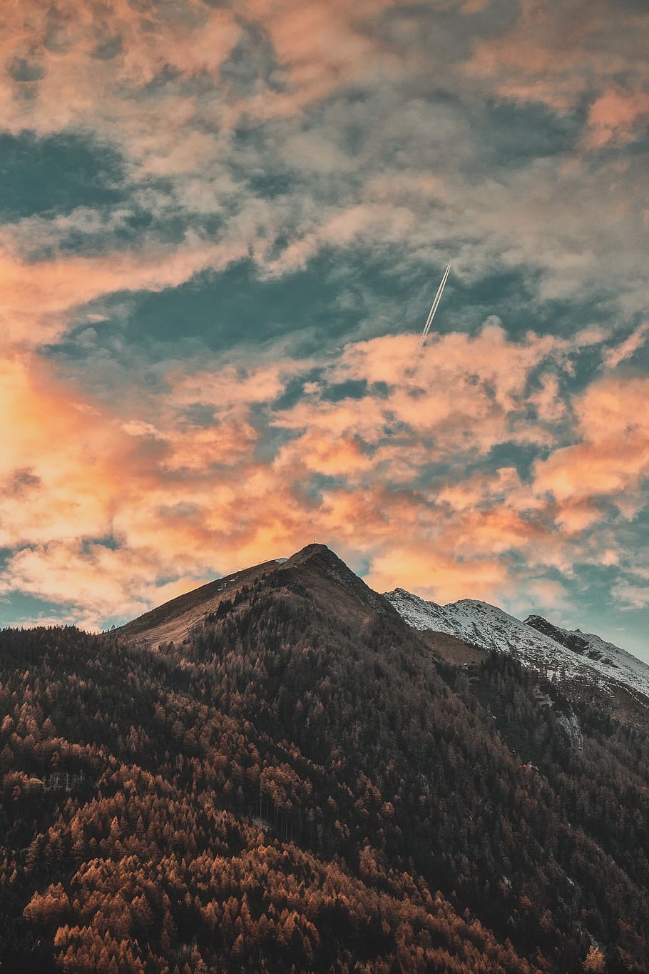 mountain top under grey and orange clouds, nature, outdoors, mountain range HD wallpaper