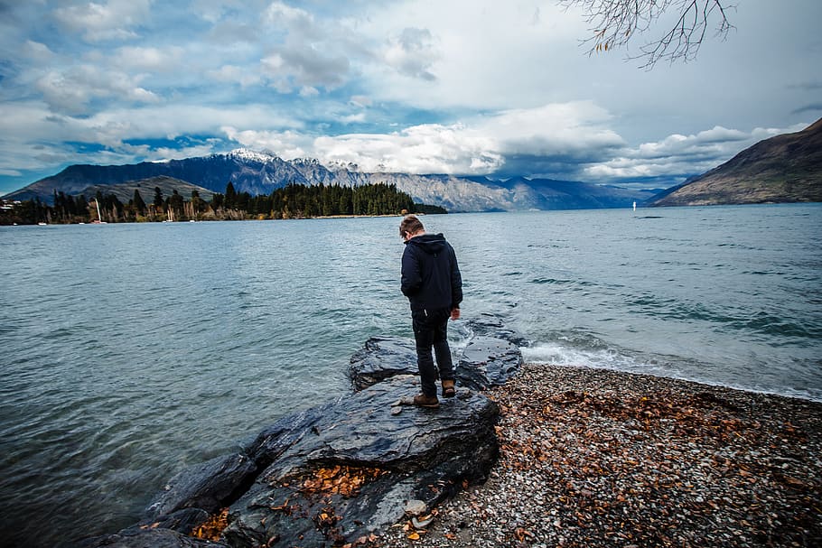 man standing on seashore under cloudy sky, real people, water HD wallpaper