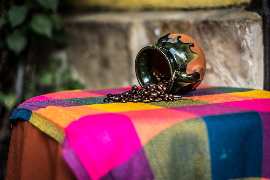 Brown and Black Ceramic Coffee Bean Rack on Pink Green and Yellow Textile HD wallpaper
