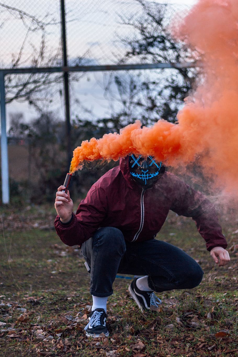 man holds orange smoke, clothing, apparel, footwear, shoe, person HD wallpaper