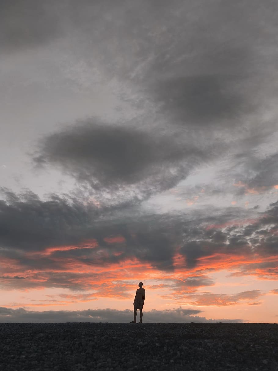 Silhouette of Man Standing Underneath Gray Sky, clouds, dawn HD wallpaper