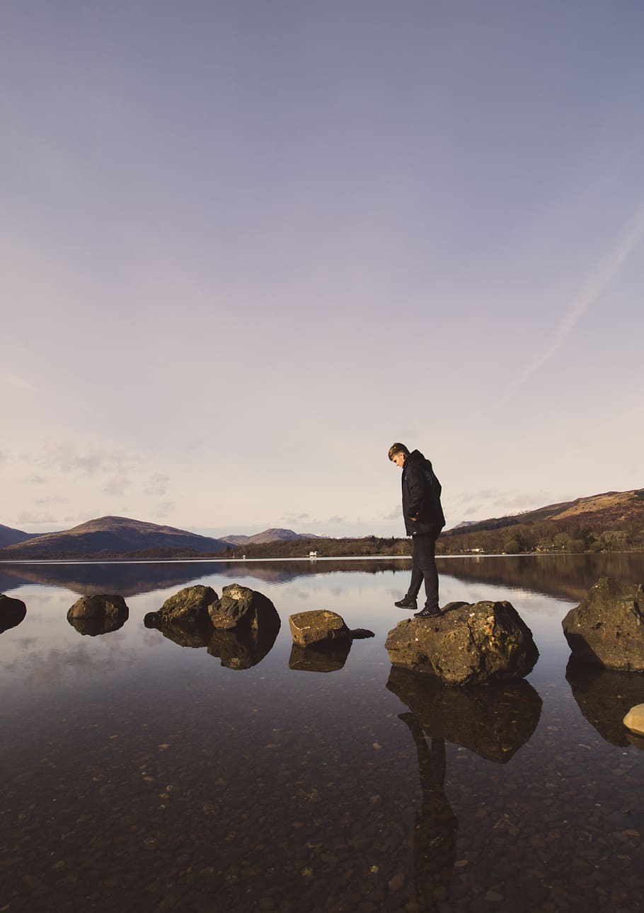 Man About to Walk on Rocks by the Body of Water, clouds, daylight HD wallpaper