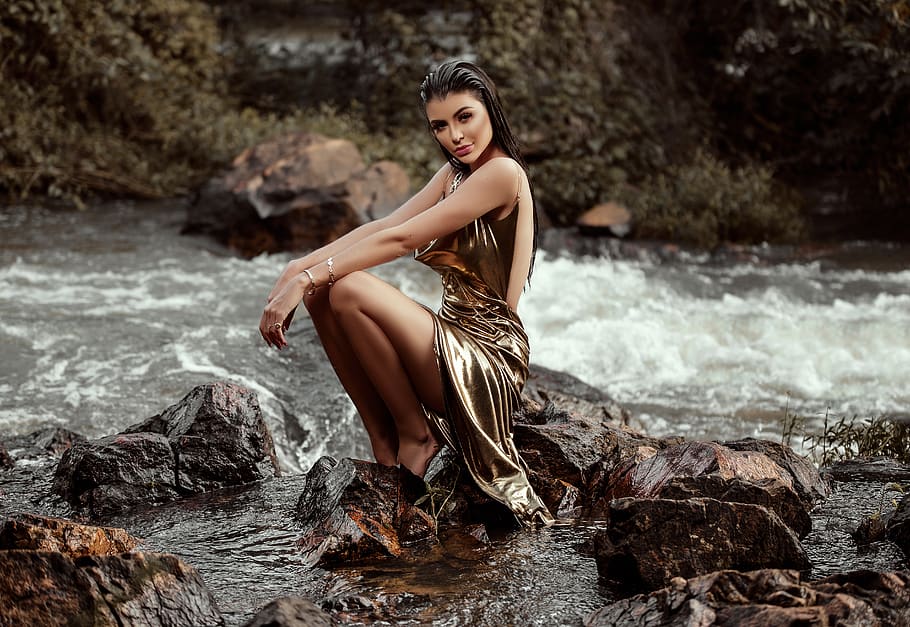 Woman in Gold Gown Sitting on Rock at the River, attractive, beautiful