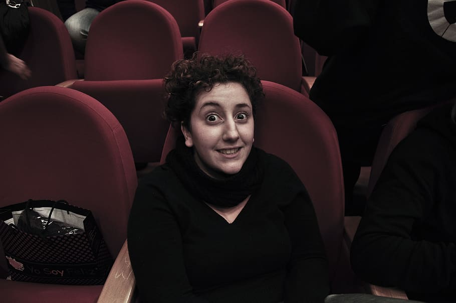 portrait, seat, looking at camera, sitting, movie theater, smiling HD wallpaper