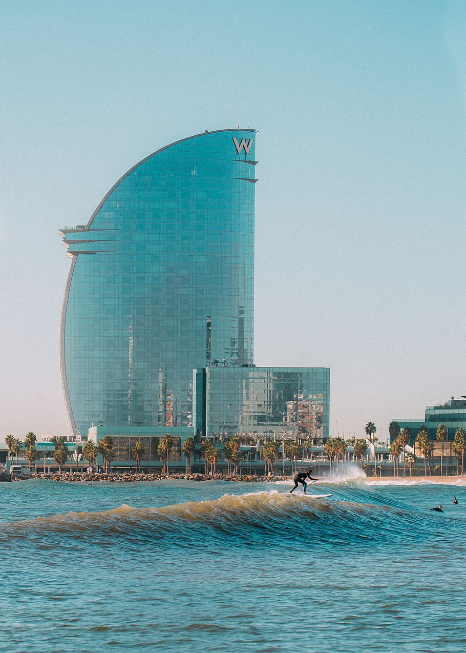 man surfing during daytime, water, building, office building HD wallpaper