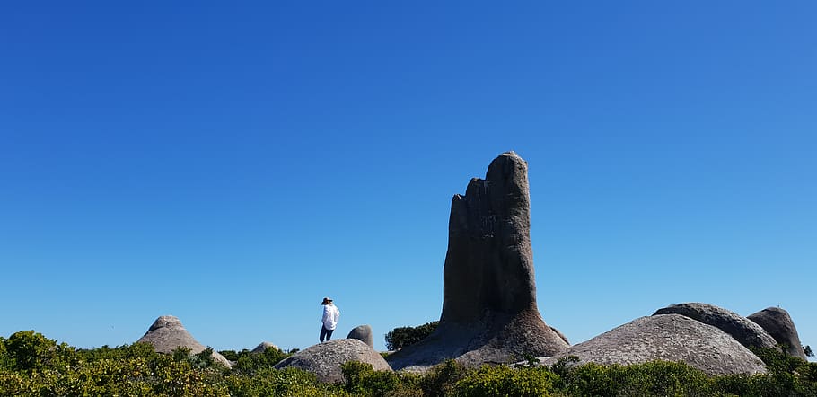 man standing on rock formations, human, person, nature, outdoors HD wallpaper