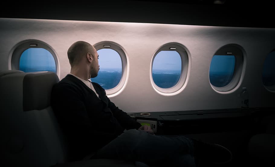man seating near window, person, human, people, porthole, flying