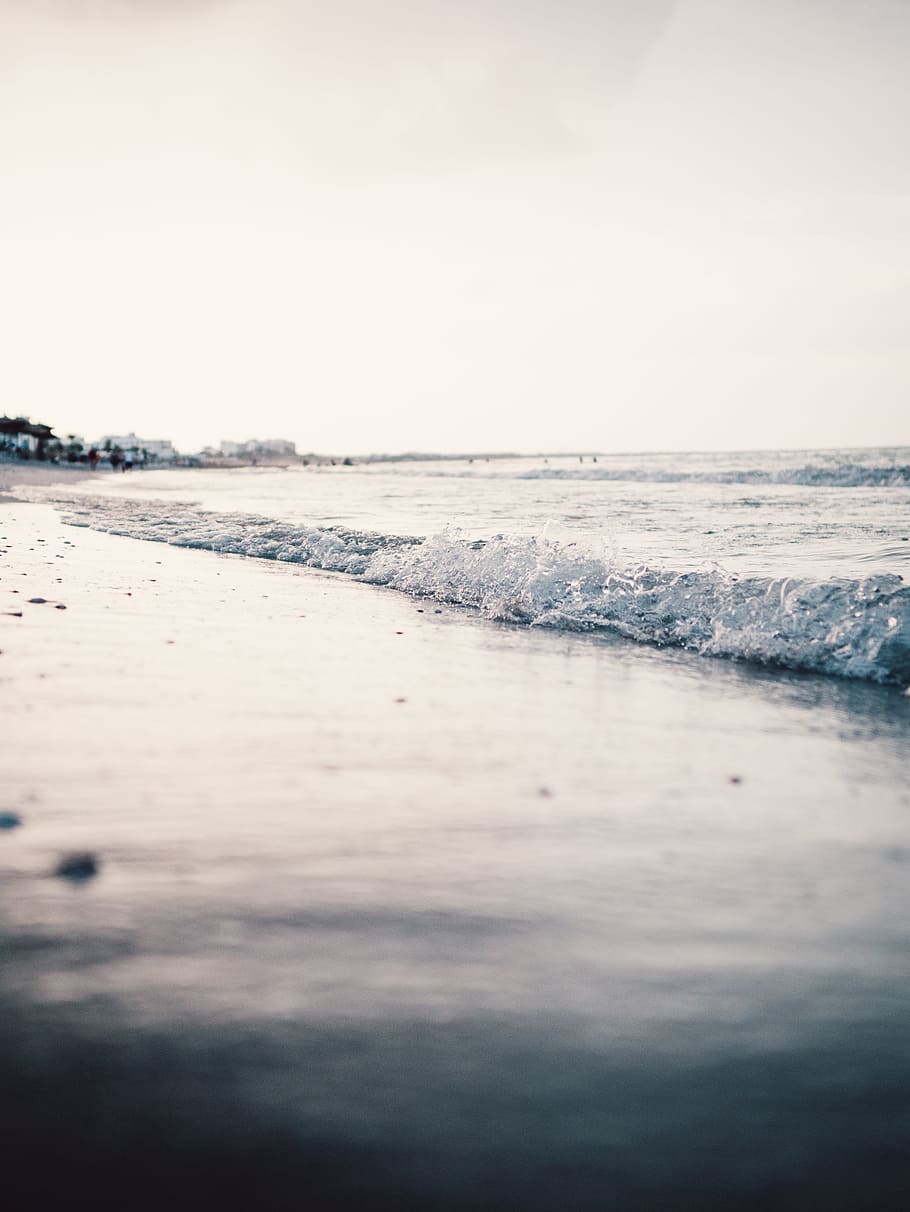 Landscape Photography of Seashore With Calm Sea Waves Under Gray Skies HD wallpaper