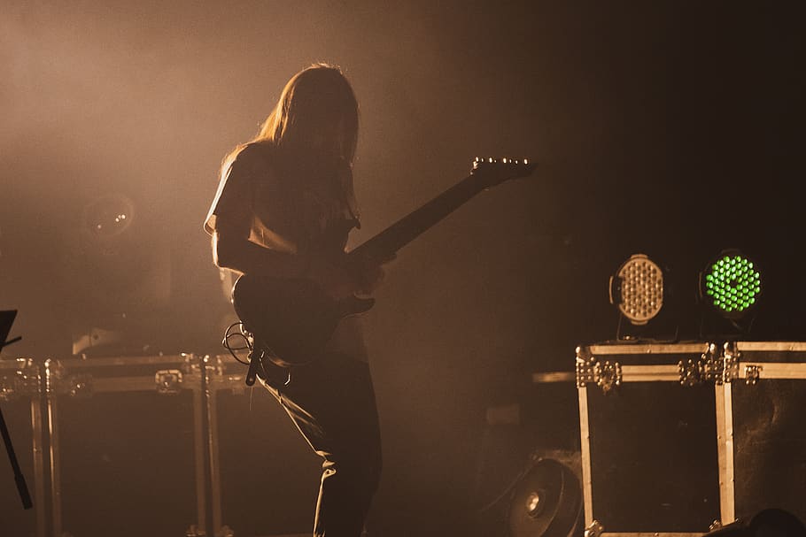 man playing electric guitar, musical instrument, leisure activities