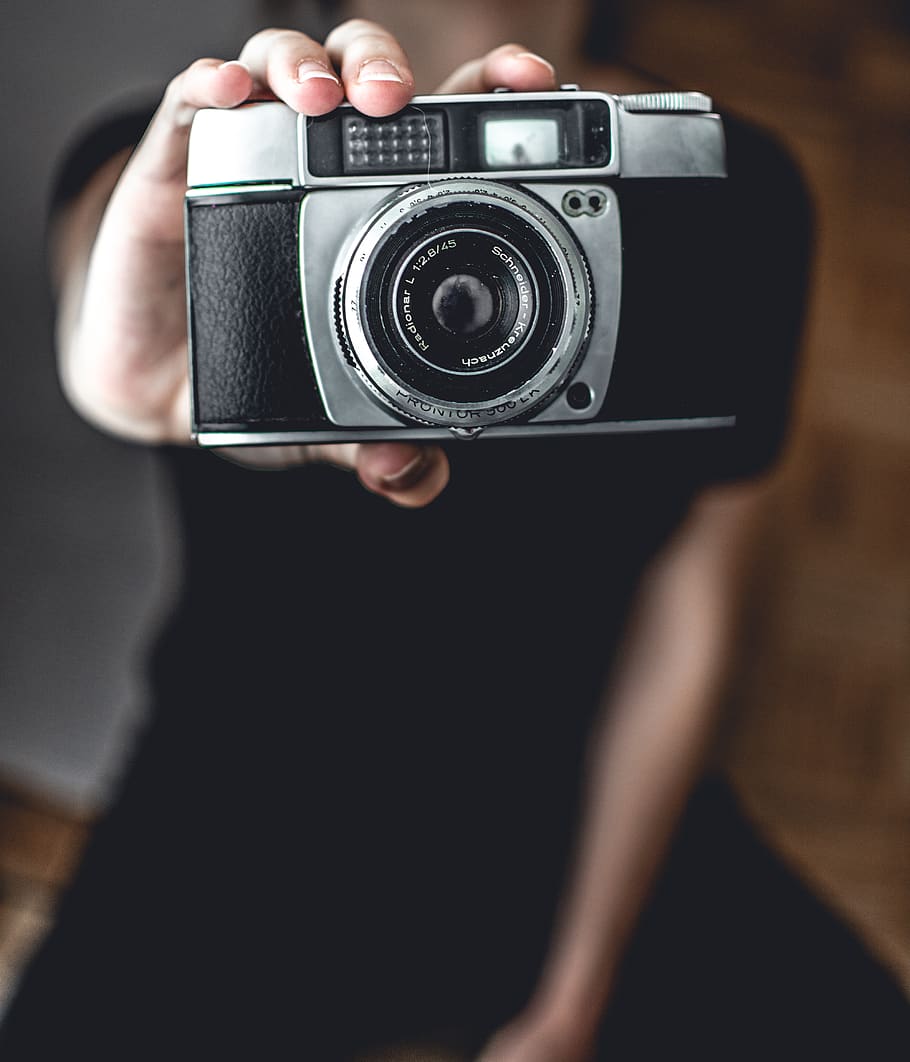 Person Holding Camera, antique, classic, electronics, macro, camera - photographic equipment HD wallpaper