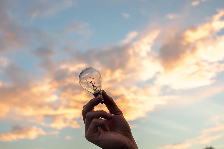 Person Holding Clear Light Bulb, backlit, clouds, dawn, hand HD wallpaper