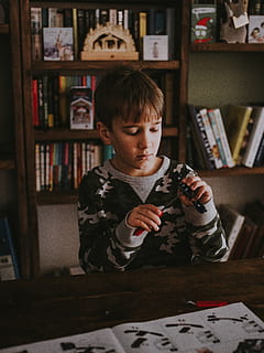 boy behind table, furniture, bookcase, shelf, human, person, couch HD wallpaper