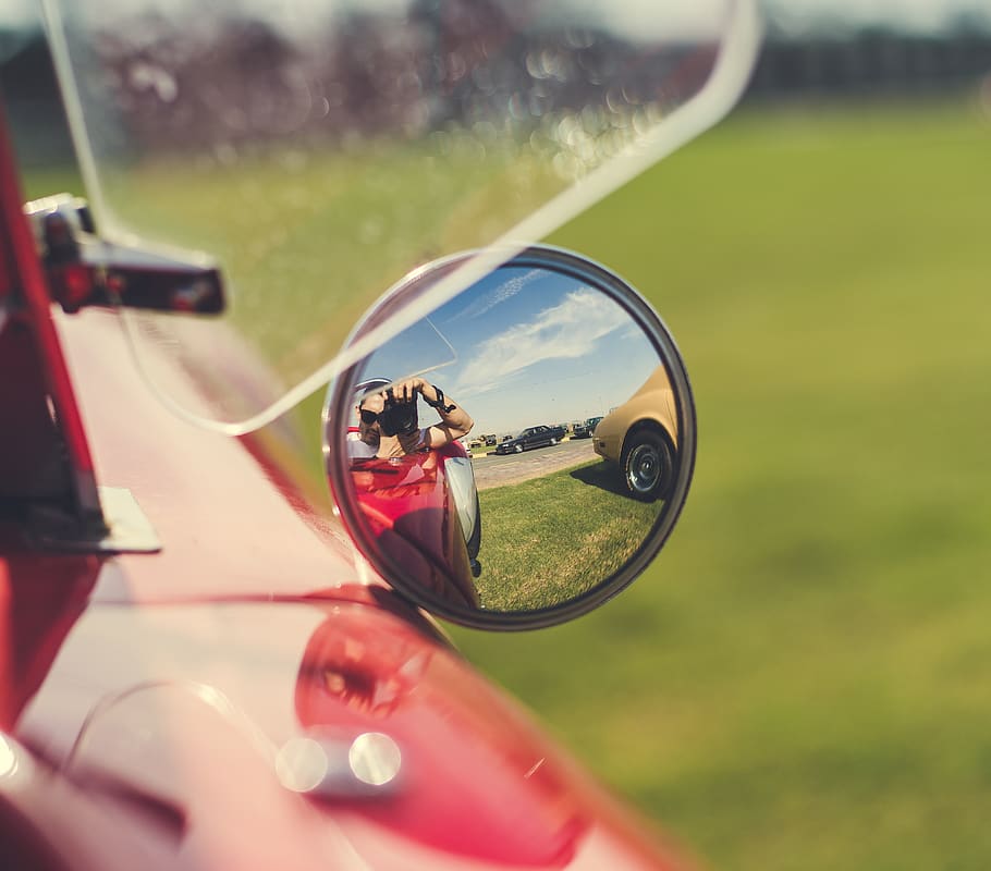 Selective Focus Photography Of Person Taking Photo On Vehicle Side Mirror HD wallpaper