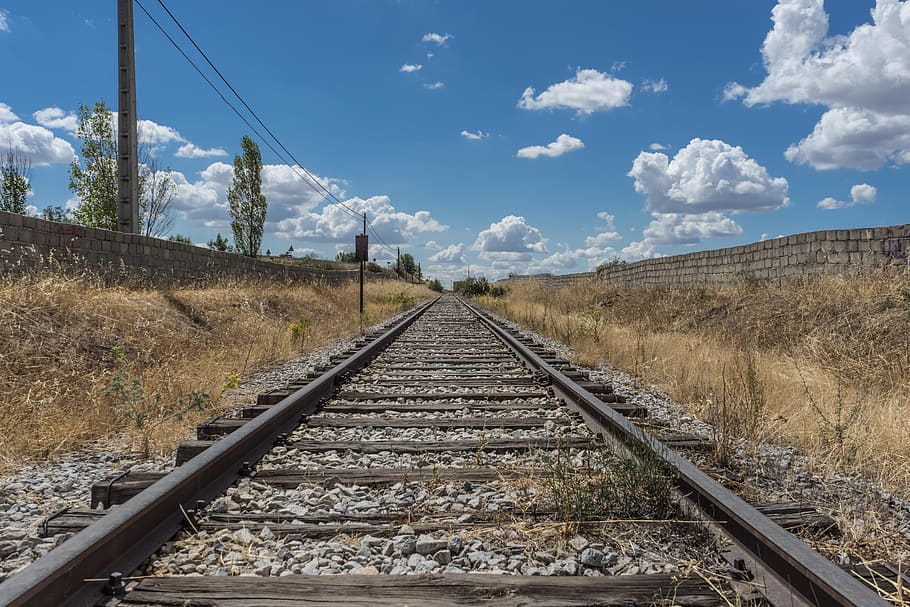 Railroad Track Amidst Trees Against Sky, daylight, empty, gravel HD wallpaper