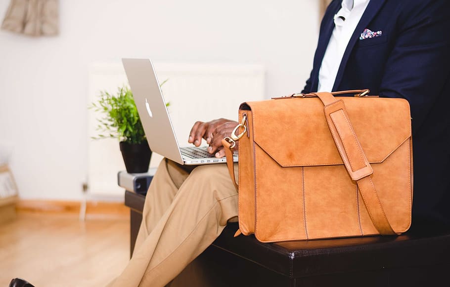 Person Wearing Blue Suit Beside Crossbody Bag and Using Macbook, HD wallpaper
