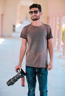 Smiling Man Holding Black Dslr Camera, boy, dlsr, eyewear, fine-looking HD wallpaper