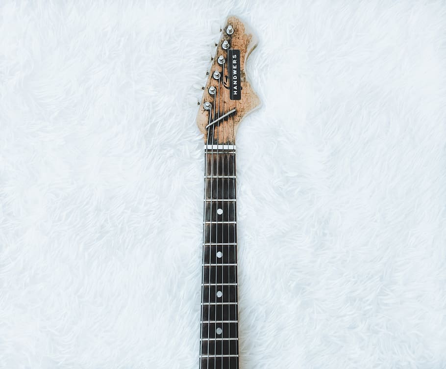 top view of electric guitar neck and headstock on white faux fur, HD wallpaper