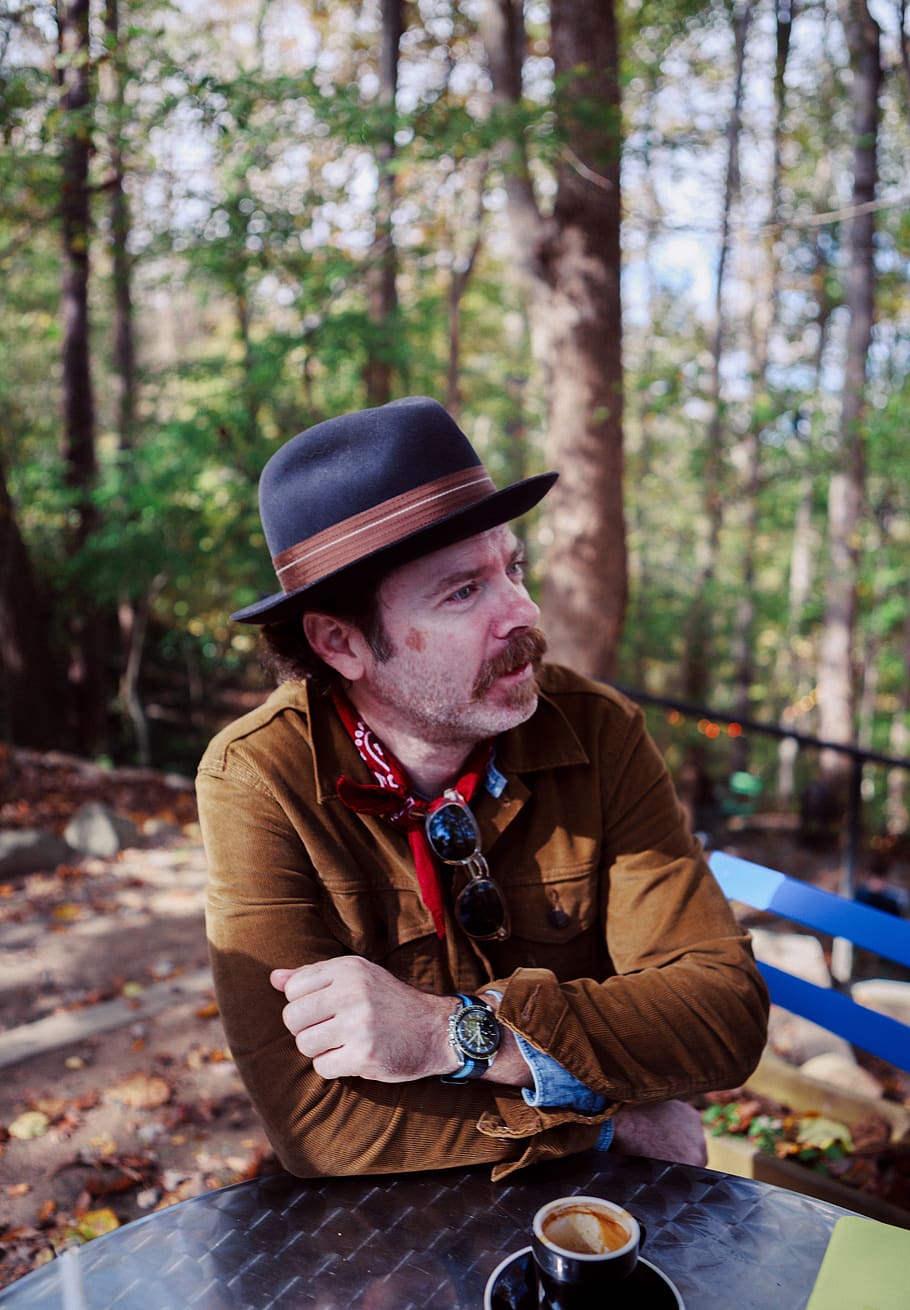 man in brown jacket lean on table, hat, person, human, apparel HD wallpaper