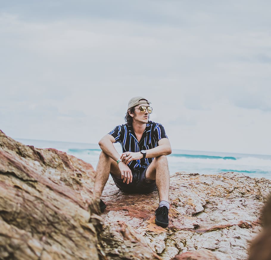 man sitting on brown rock, human, person, outdoors, leisure activities HD wallpaper