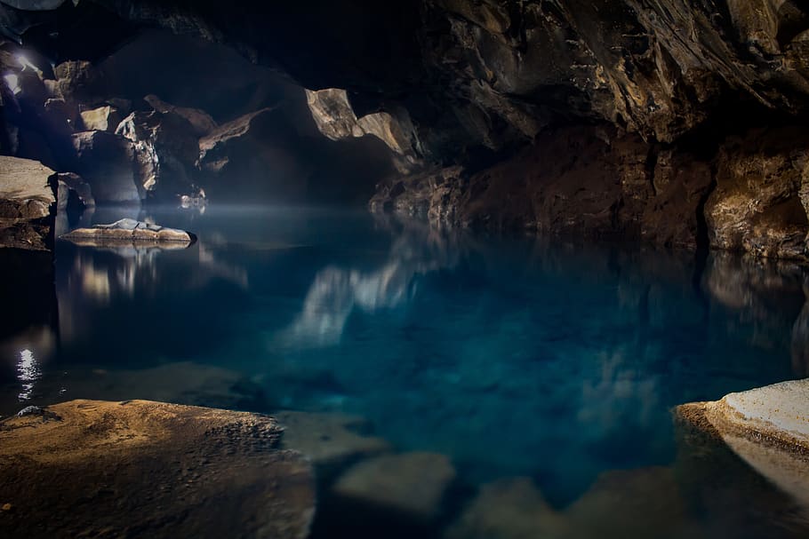 brown boat in body of water inside the cave, nature, grjótagjá