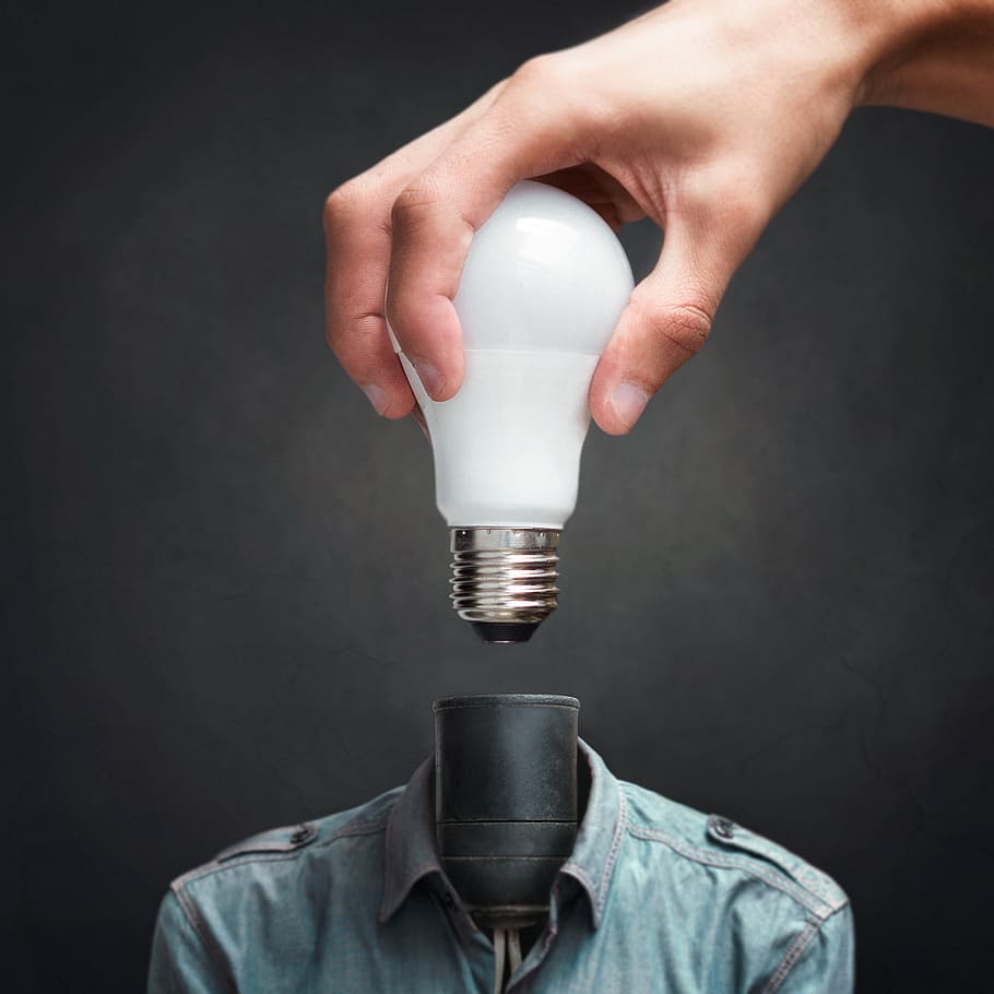 Person Holding White Light Bulb Beside Black Bulb Socket, art, HD wallpaper
