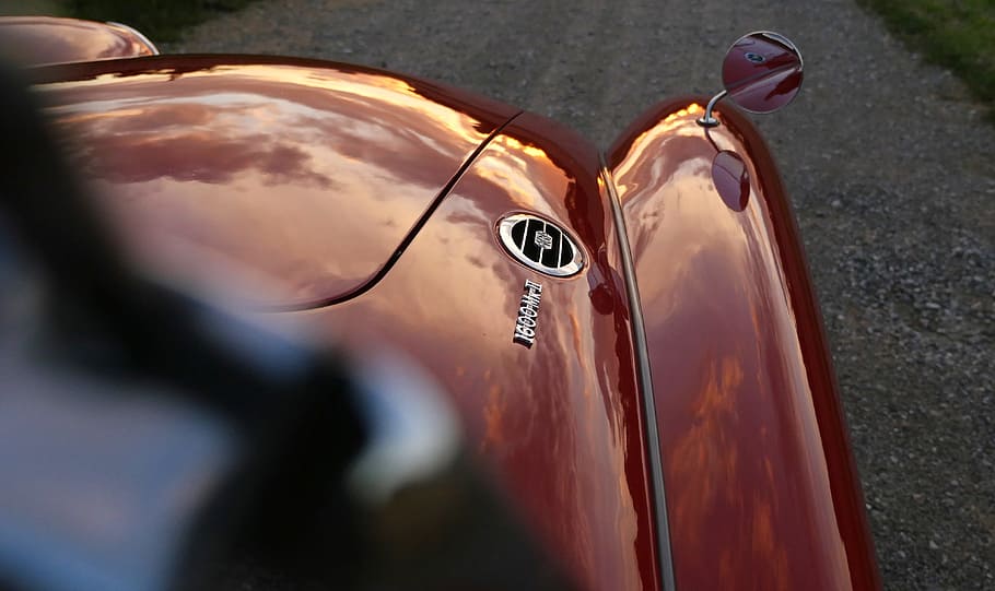 Red Vehicle With Wing Mirror on Its Hood Outdoors during Day HD wallpaper