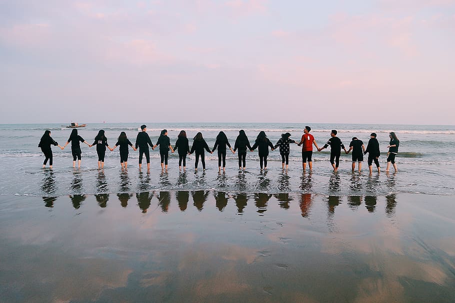 Team Holding Their Hands On Seashore, beach, ocean, people, reflection HD wallpaper