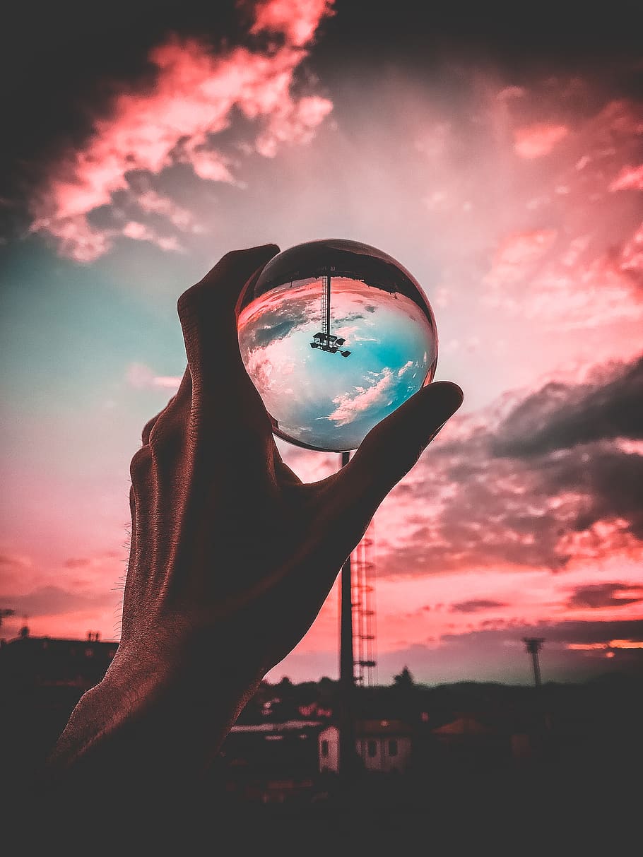 Person Holding Clear Glass Ball, clouds, evening, hand, sunset HD wallpaper