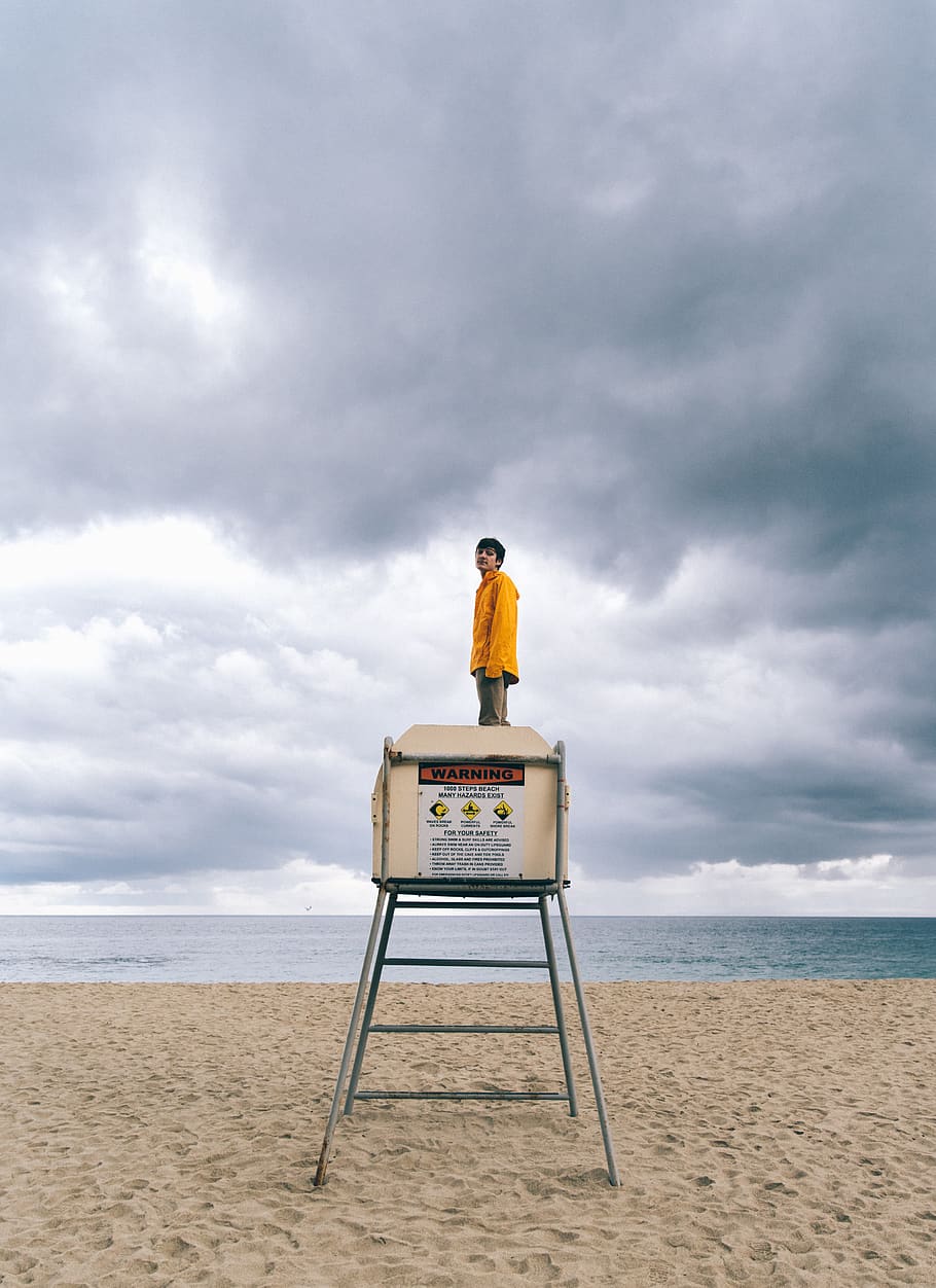 person standing on beige drum, beach, sky, sea, land, cloud - sky HD wallpaper