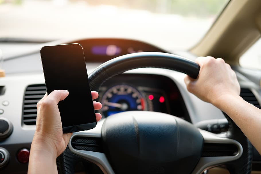 Person Holding Black Smartphone and Vehicle Steering Wheel, car