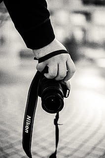 person holding Nikon camera, human, electronics, strap, finger HD wallpaper