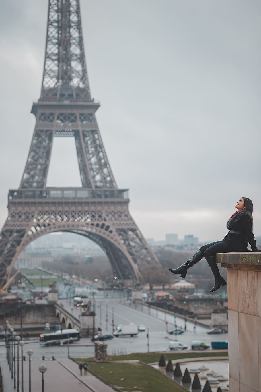 Woman Sitting on Buildings Rooftop Near Eiffel Tower, Paris, architecture
