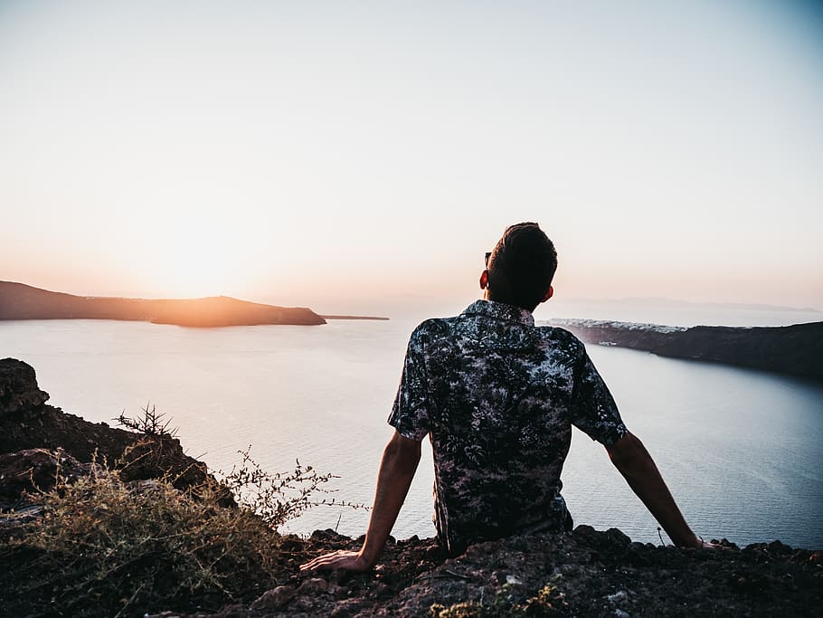 man sitting on rock while looking at sunset, human, person, people HD wallpaper