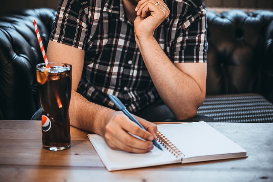 Man Holding Blue Pen Writing on White Notepad, cola, drink, glass HD wallpaper
