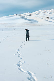 Man Standing on Snow Area, camera, cold, daylight, explore, footprints HD wallpaper