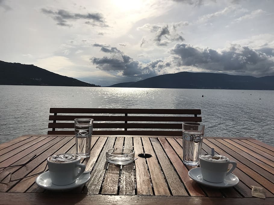 pottery, saucer, coffee cup, water, waterfront, furniture, bench