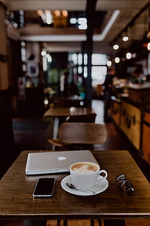 Cup of coffee on table in cafe, interior, tech, technology, work HD wallpaper