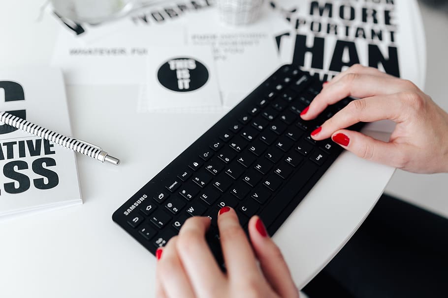 Female hands typing on the remote wireless computer keyboard HD wallpaper
