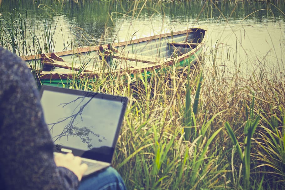 Person Using Black Laptop Computer Near Green Boat, digital nomad HD wallpaper