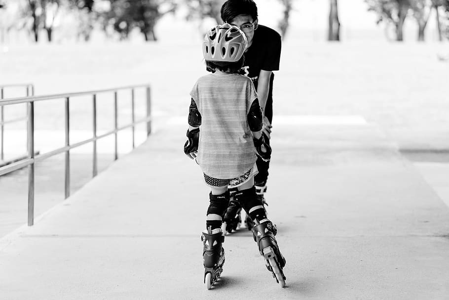 grayscale photo of man and girl using inline skates near railings, HD wallpaper