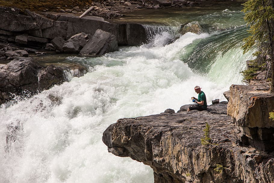 man sitting beside river during daytime, solid, rock, water, rock - object HD wallpaper