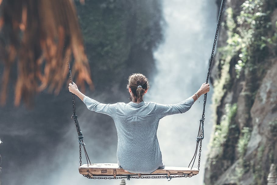 Woman Riding Big Swing in Front of Waterfalls, action, adult