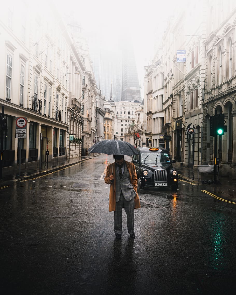 man holding umbrella, person, people, human, vehicle, car, transportation