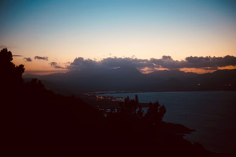 silhouette photography of mountain near body of water, nature