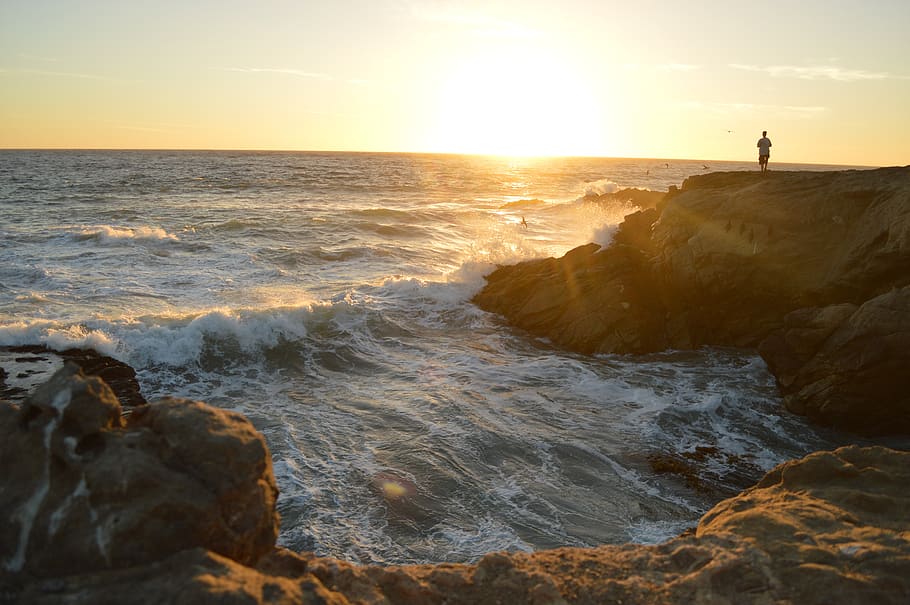 coast, shore, cliffs, craggy, rocks, summer, sunset, person HD wallpaper