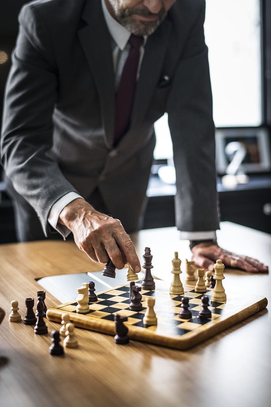 Download A Person Is Playing Chess On A Board Wallpaper