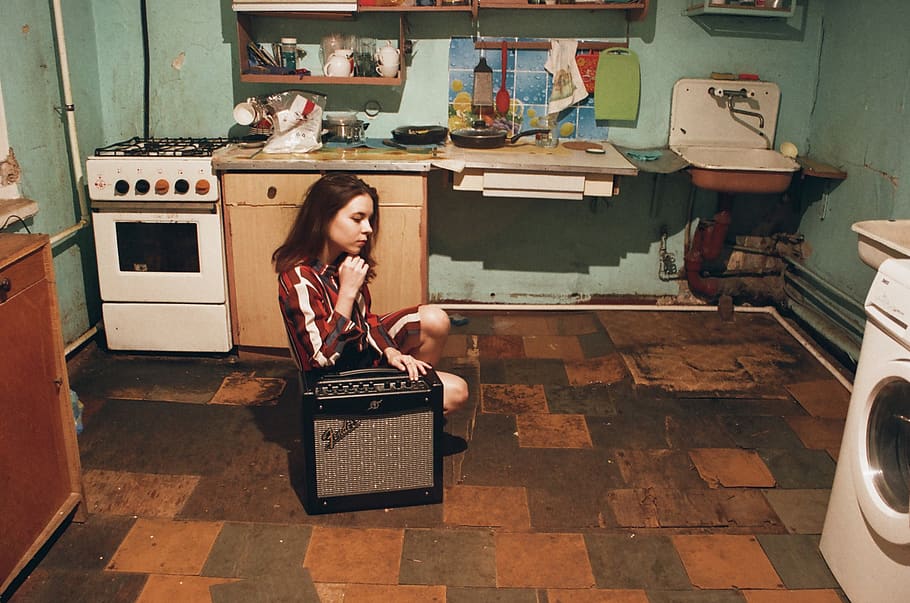 Girl Sitting Beside Gray and Black Fender Guitar Amplifier Inside Room HD wallpaper