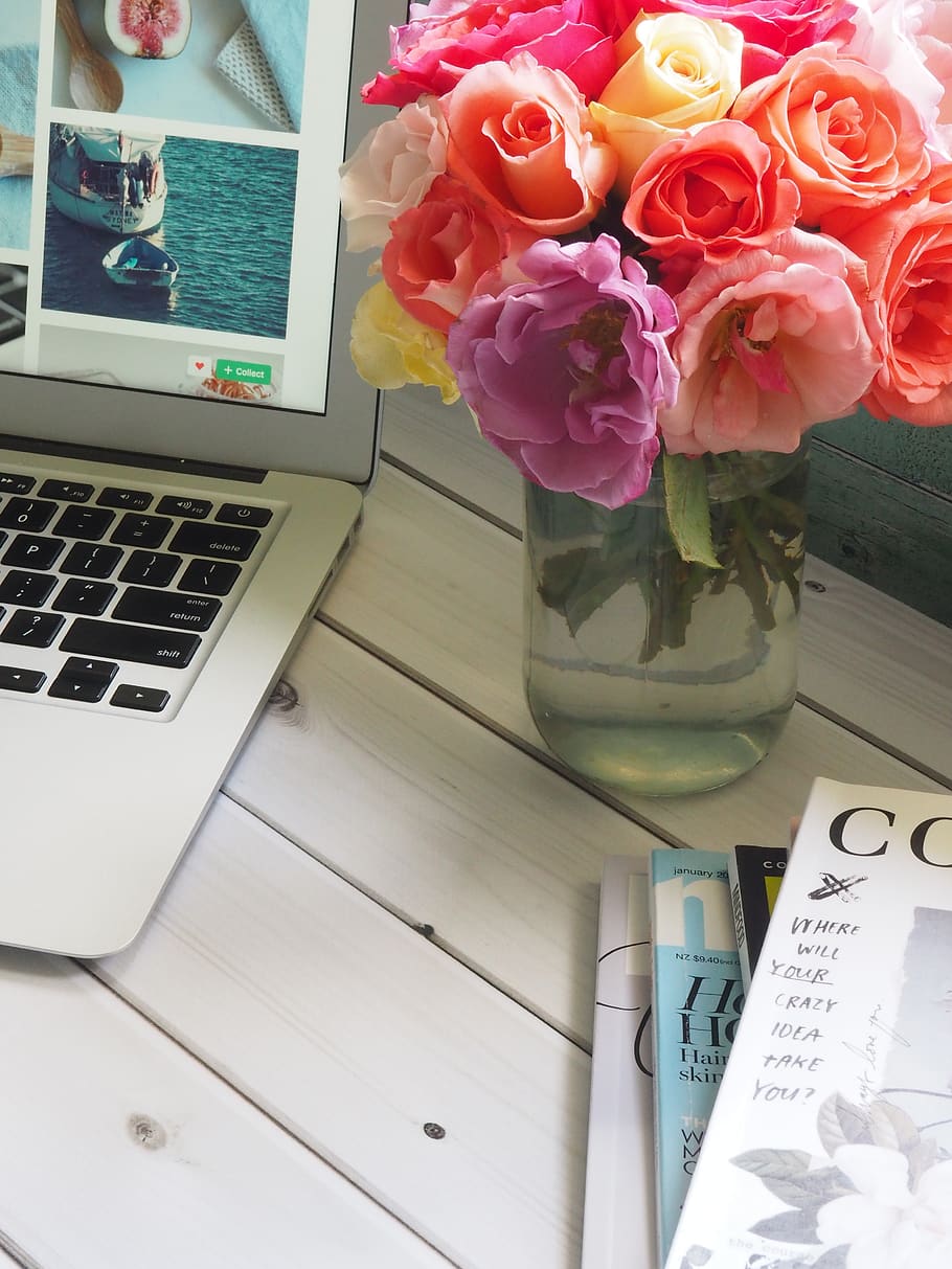 Assorted-color Flower Arrangement in Clear Glass Vase Beside a Laptop HD wallpaper