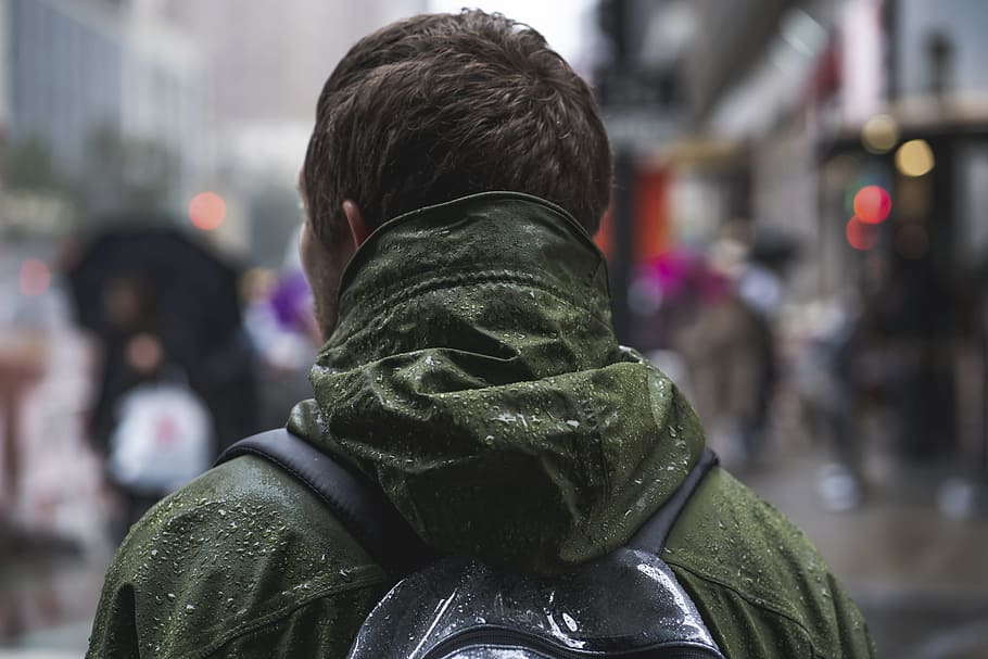 close-up photography of man wearing green hoodie, downtown, perspective HD wallpaper