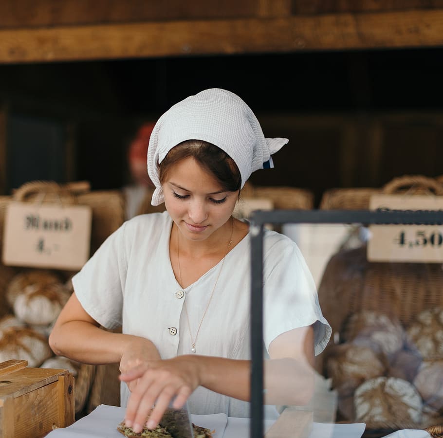 woman slicing bread, one person, real people, women, waist up HD wallpaper